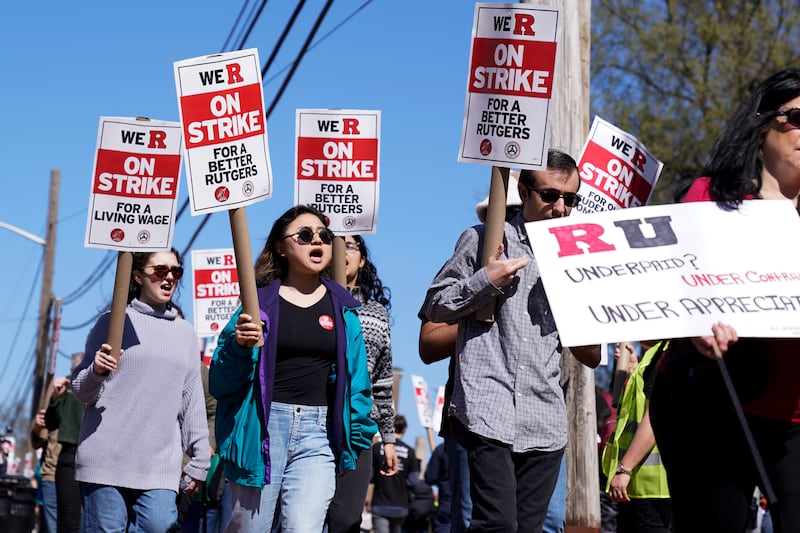 Strikers march in front of Rutgers University in New Brunswick, N.J.