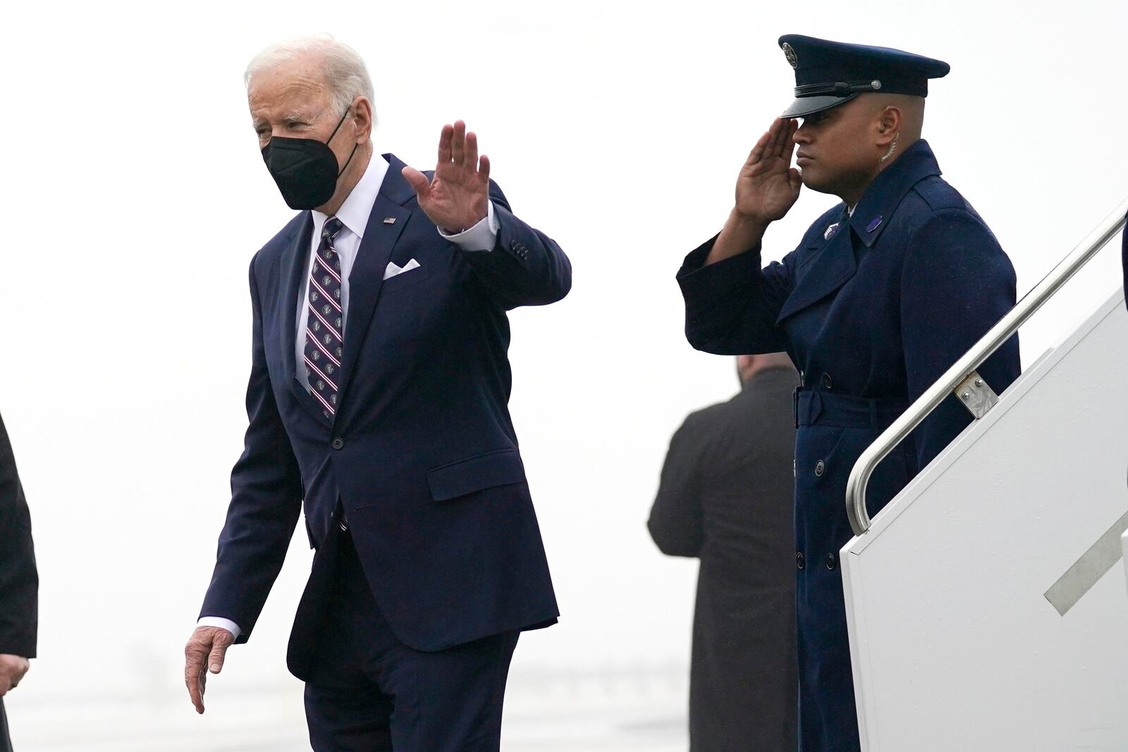 President Joe Biden waves as he steps off Air Force One upon arrival at John F. Kennedy Airport.