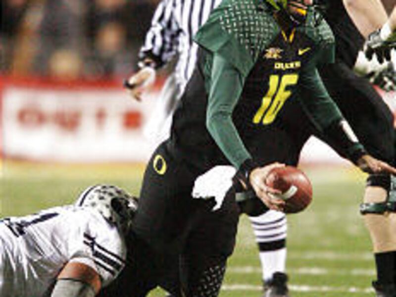 Brigham Young University's Russell Tialavea sacks Oregon QB Brady Leaf during the Las Vegas Bowl.