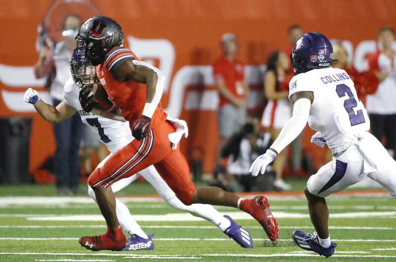 Utah Utes wide receiver Theo Howard (wearing red) runs against the Weber State Wildcats