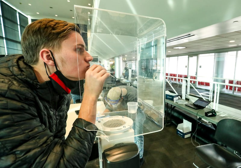 University of Utah freshman Daniel Wray swabs his nostril as he takes a rapid COVID-19 test at Rice-Eccles Stadium in 2020.