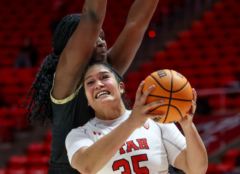 Utah Utes forward Alissa Pili (35) drives and shoots against Colorado Buffaloes center Aaronette Vonleh (21) at the Jon M. Huntsman Center in Salt Lake City on Wednesday, Dec. 14, 2022.