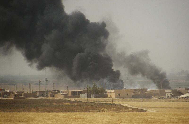 Smoke rises during a military operation launched by Kurdish troops known as peshmerga to regain control of some villages from the Islamic State group, in the oil-rich city of Kirkuk, 180 miles (290 kilometers) north of Baghdad, Iraq, Wednesday, Sept. 30,