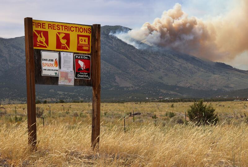 A fire restriction sign along a road in Rush Valley as a wildfire burns on Victory Mountain in Morgan Canyon in Tooele County.