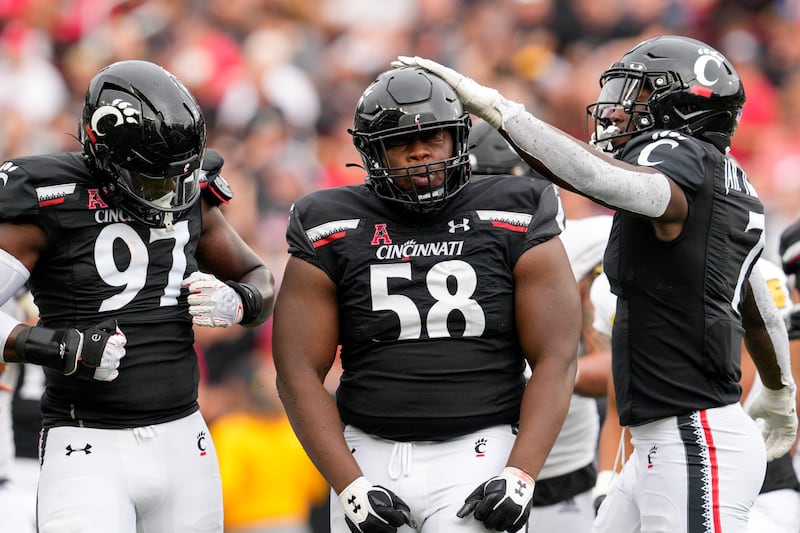 Cincinnati defensive lineman Dontay Corleone (58) celebrates with teammates after a tackle against Kennesaw State.