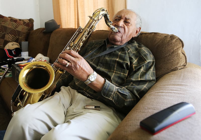 Saxophone player Joe McQueen, still going strong as he nears his 99th birthday, Joe plays a tune on his horn at his Ogden home on Saturday, May 26, 2018.