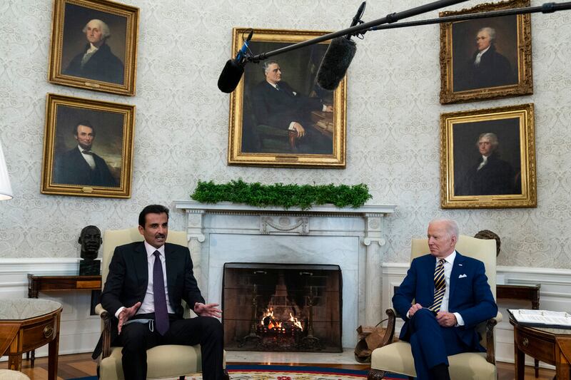 Qatar’s Emir Sheikh Tamim bin Hamad Al Thani, left, speaks during a meeting with President Joe Biden, right.