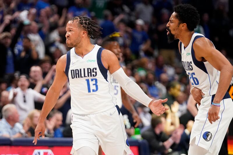 Dallas guard Jalen Brunson (13) and Spencer Dinwiddie celebrate a 3-point basket made by Brunson against the Utah Jazz.