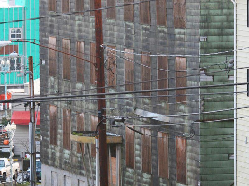 In this Monday, Nov. 28, 2011 photo, city officials in Ketchikan, Alaska, confirm that the deterioration of the former hospital on Bawden Street, continues as predicted with the recent snow and rainfall.