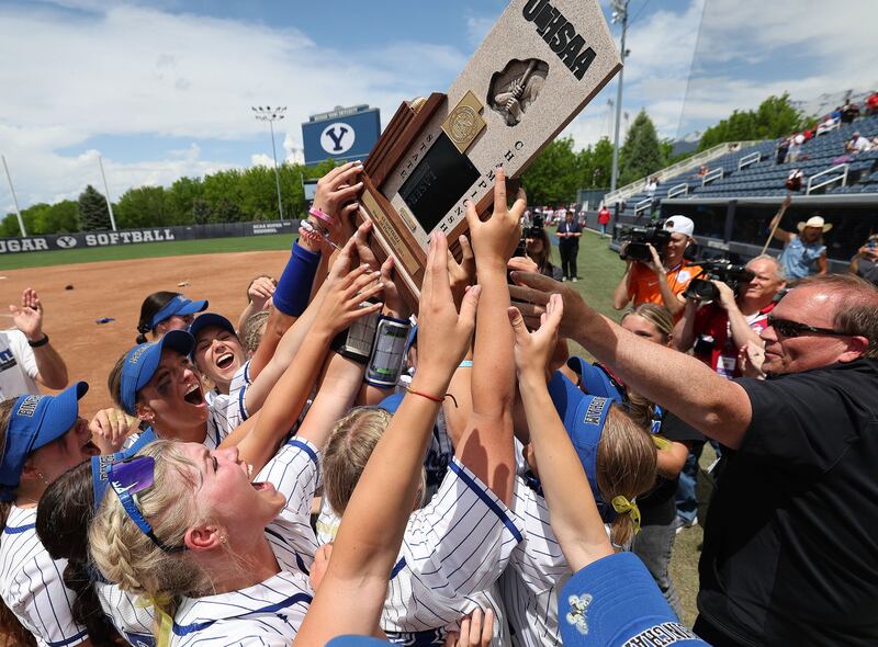 Bingham players celebrate their win over Herriman in the 6A softball state championship in Provo on May 26, 2023.
