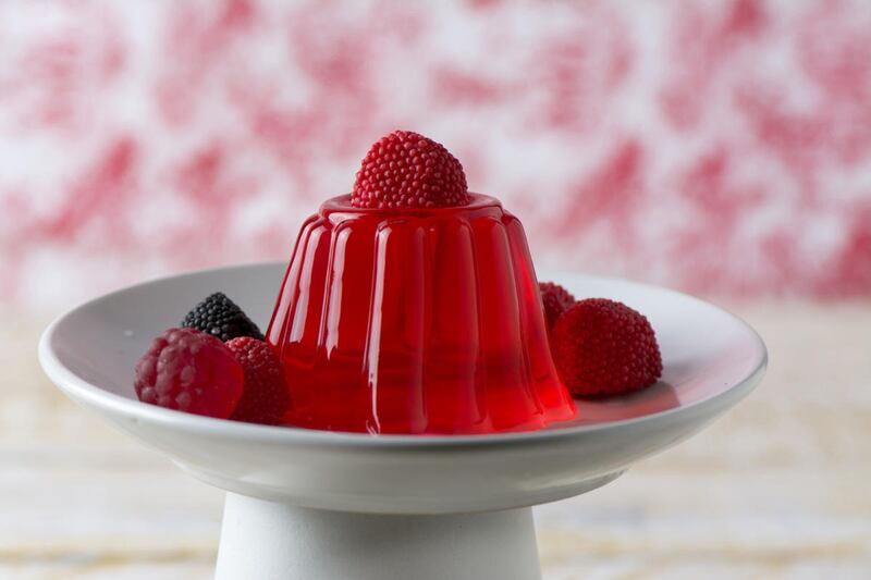 A homemade red cherry gelatin dessert on a cakestand