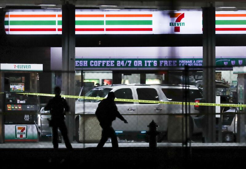 Crime tape and a heavy police presence surround a 7-Eleven in Taylorsville on Dec. 1 where two police officers were shot and a gunman was killed in a barrage of gunfire at 4110 S. Redwood Road.