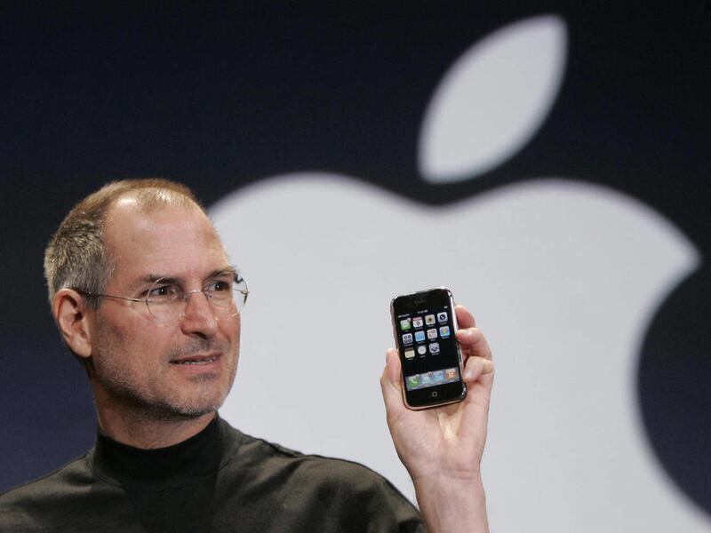 FILE - In this Jan. 9, 2007 file phtoo, Apple CEO Steve Jobs holds up an Apple iPhone at the MacWorld Conference in San Francisco. Apple Inc. on Wednesday, Aug. 24, 2011 said Jobs is resigning as CEO, effective immediately. He will be replaced by Tim Cook