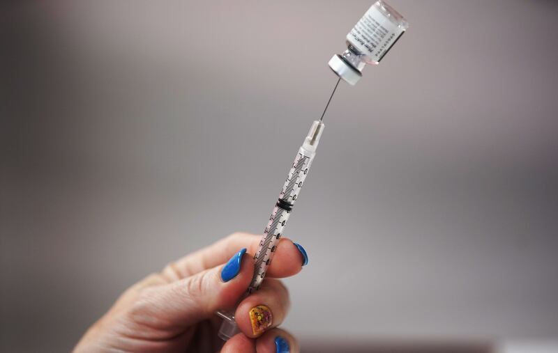 A COVID-19 vaccine is prepared during a Utah County Health clinic.