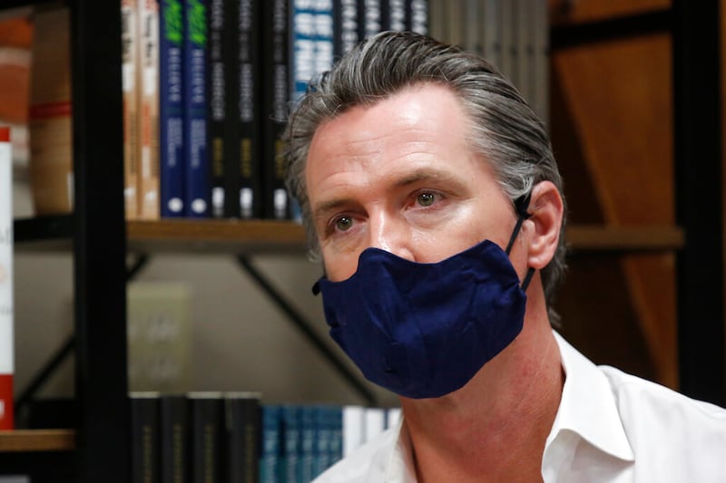 California Gov. Gavin Newsom wears a face mask during his stop at the Legendary Coffee and Books in Stockton, Calif., on June 4, 2020.