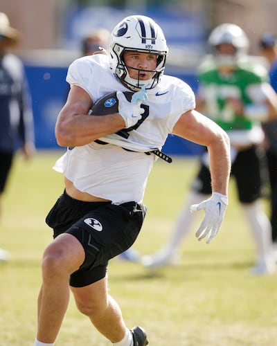 BYU tight end Walker Lyons runs after a catch during spring drills at BYU's outdoor practice facility on March 2, 2026.
