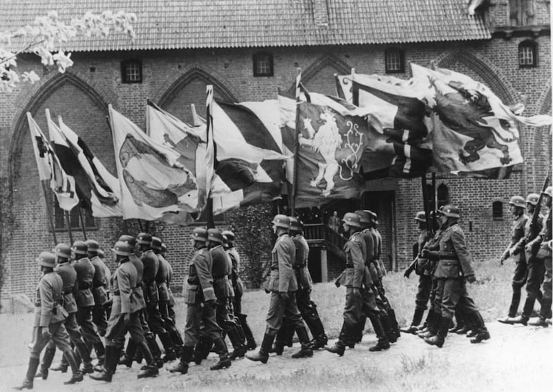 German soldiers march in formation of fours carrying the 430-year-old flags, which the German Order of Knights lost in the battle of Tannenberg July 15, 1410, against a twice as large Slav force. The flags had been hanging in the Wawel Castle in Cracow, P