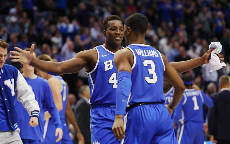 BYU’s forward Fousseyni Traore (45) chest bumps with teammate Rudi Williams (3)
