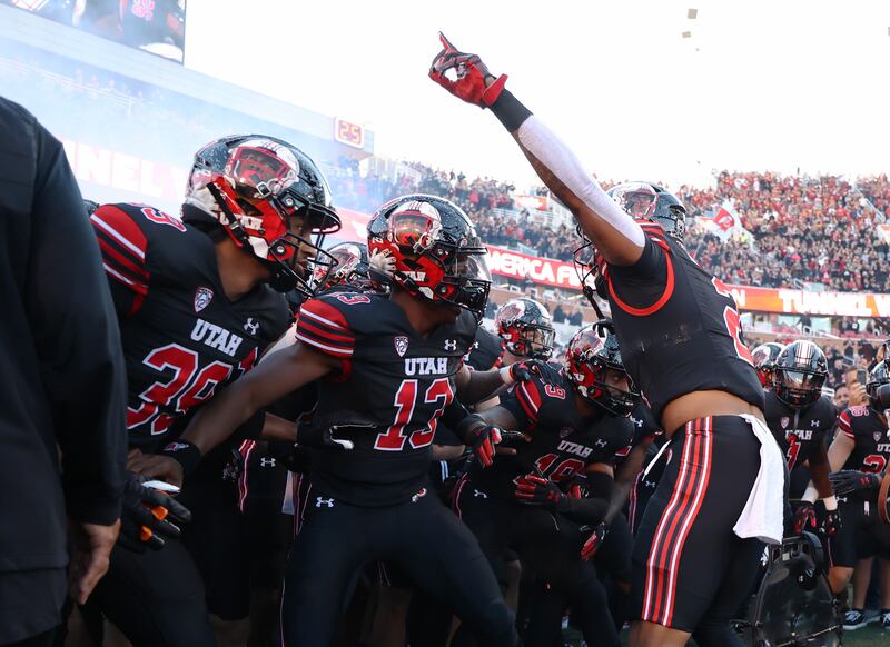 Utah players run onto the field ahead of a game against USC at Rice-Eccles Stadium in Salt Lake City on Saturday, Oct. 15, 2022.
