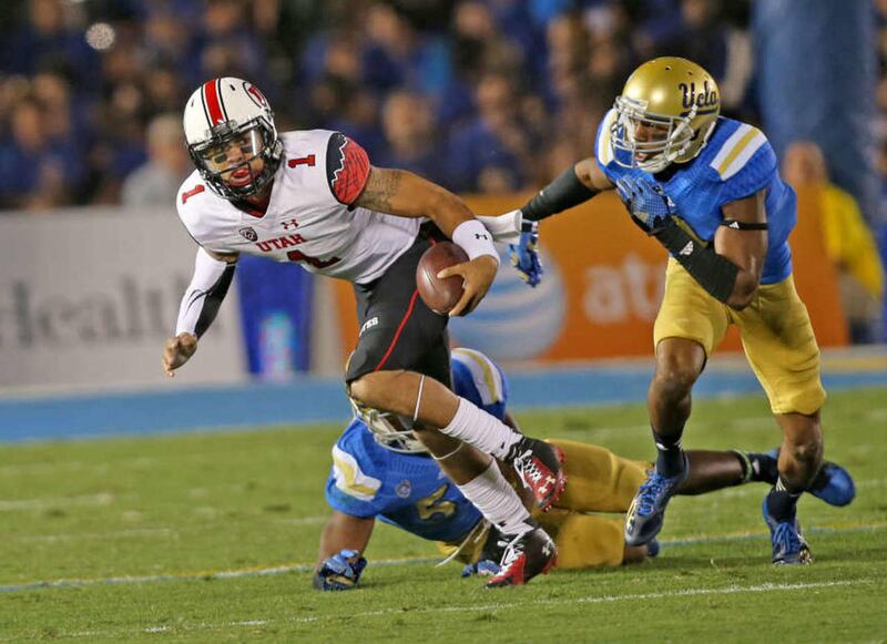 Utah Utes quarterback Kendal Thompson (1) eludes UCLA's Ismael Adams as the University of Utah plays UCLA in the Rose Bowl during NCAA PAC 12 football action Saturday, Oct. 4, 2014, in Pasadena.