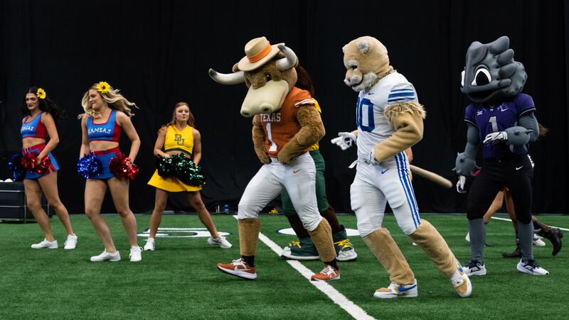 Mascots and cheerleaders from various schools dance together at the NCAA college football Big 12 Media Days in Arlington, Texas, Thursday, July 13, 2023.