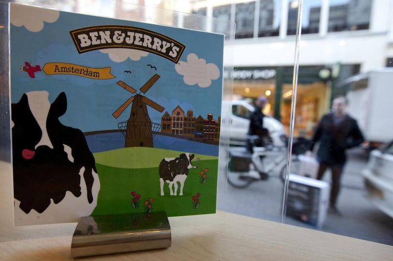 People pass a Ben & Jerry’s ice cream franchise store in Amsterdam, Netherlands, Thursday Feb. 2, 2012. Unilever PLC, the company behind consumer staples like Lipton teas, Dove soaps, Ben & Jerry’s and Magnum ice cream, struggled throughout 2011 to pass o