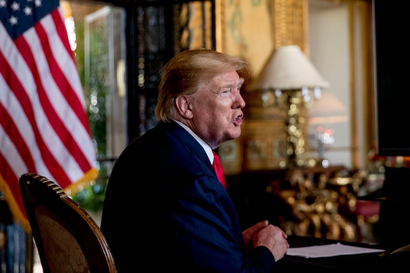 FILE - In this Dec. 24, 2019 photo, President Donald Trump speaks to members of the media following a Christmas Eve video teleconference with members of the military at his Mar-a-Lago estate in Palm Beach, Fla. Trump says Iranian Gen. Qassem Soleimani, the target of a Friday U.S. airstrike in Iraq was “plotting to kill” many Americans. (AP Photo/Andrew Harnik)
