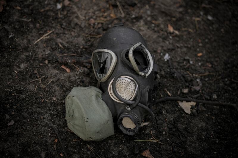 A damaged gas mask lies in the dirt in Ukraine.