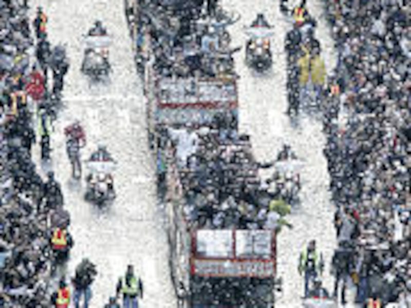 White Sox players travel in a ticker-tape parade in the downtown business district of Chicago.