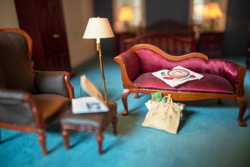 A miniature room setting in the dollhouse Larry Elkins built has a crossword puzzle and cross-stitch that he and his wife would do together, as seen on Wednesday, March 27, 2019. Elkins built the dollhouse modeling the dream home he and his late wife Lind