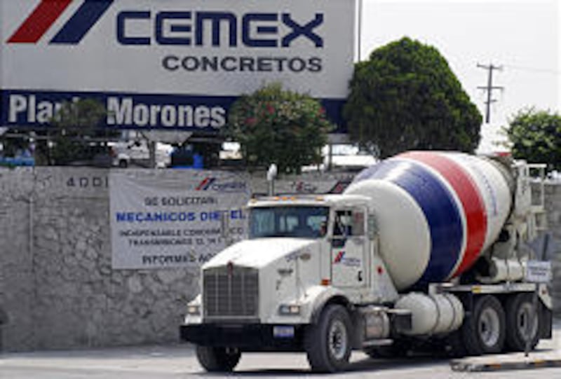A cement truck leaves the Cemex SA center in Monterrey, Mexico, Thursday. Cemex is now the largest supplier of building materials.