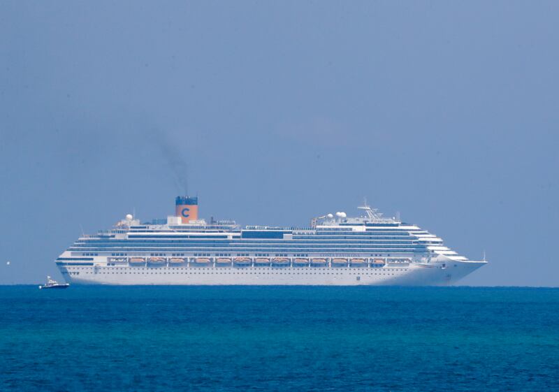 The Costa Cruise ship Favolosa is shown, Thursday, March 26, 2020, off the coast of Miami Beach, Fla. Miami-area hospitals received crew members Thursday from two Costa Cruise ships, the Magica and Favolosa. Carnival Corp., which owns the cruise line, said the ships are empty except for crew members. Carnival said that the ships had tried to dock in several Caribbean ports to get treatment due to the coronavirus for the crew members, but had been turned away. (AP Photo/Wilfredo Lee)