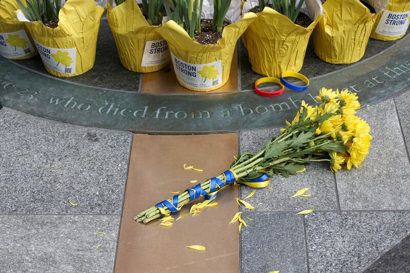 Flowers are placed at a memorial for victims of the 2013 Boston Marathon bombing on the 10th anniversary of the attack.