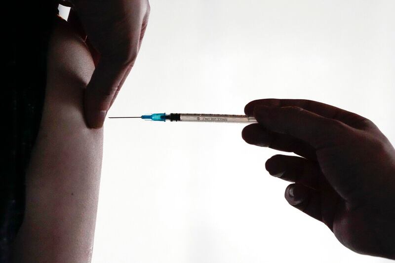 A doctor administers a COVID-19 vaccine.