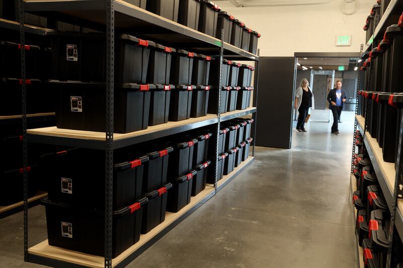 Patrice Dickson, chief operating officer of social services for Utah Community Action, and Andrew Johnston, vice president of program operations for Volunteers of America-Utah, walk past the client storage room at the Geraldine E. King Women's Resource Ce