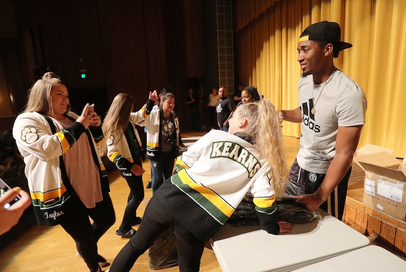 Utah Jazz player Donovan Mitchell poses for a photo with Emily Dutson while handing out backpacks to students at Kearns High in Kearns on Tuesday, Aug. 21, 2018. Taylor Miller shoots the photo.