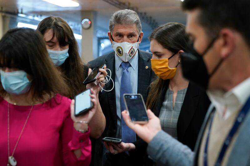 Sen. Joe Manchin, D-W.Va., center, speaks with reporters on Capitol Hill in Washington on Wednesday.