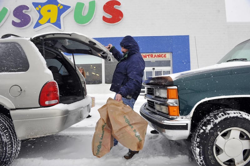 FILE - In this Dec. 20, 2009 file photo, Raymond Brockmann, of North Attleboro, Mass., shops at a Toys "R" Us store in North Attleboro.