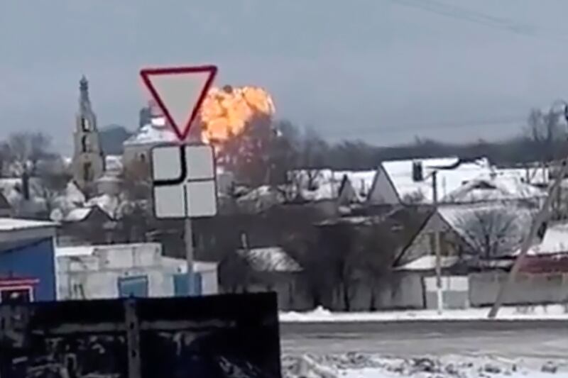 This handout photo taken from validated UGC video shows flames rising from the scene of a warplane that crashed at a residential area near Yablonovo, Belgorod region.