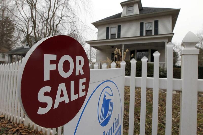 This Feb. 8, 2012 photo, shows a for-sale sign in front of a home in Yardley, Pa. Time magazine says more unmarried couples are buying homes together.