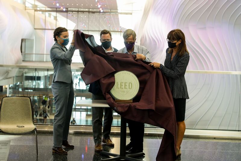 Salt Lake City Mayor Erin Mendenhall, left, Matt Needham, director of aviation and transportation at architecture, engineering and urban planning firm HOK, Bill Wyatt, executive director of the Salt Lake City Department of Airports, and Lisa Stanley, director of technical solutions for the U.S Green Business Council, unveil a LEED gold certification award during a celebration on Wednesday, Sept. 15, 2021, marking the first anniversary of the opening of Phase 1 of the Salt Lake City International