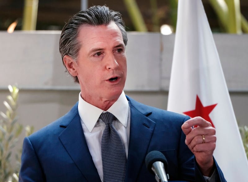 California Gov. Gavin Newsom answers questions at a news conference.