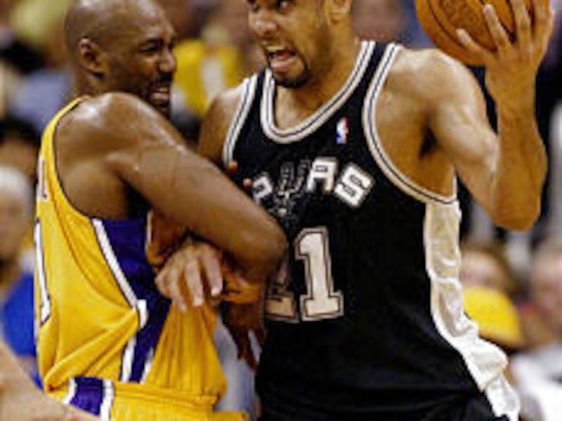 The Lakers' Karl Malone gets tied up with the Spurs' Tim Duncan during second-half action in Game 4 of the NBA playoffs.