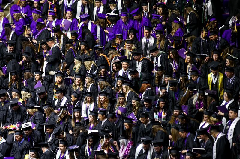 Graduate candidates take their seats at the start of Weber State University’s commencement at the Dee Events Center in Ogden on Friday, April 26, 2019.