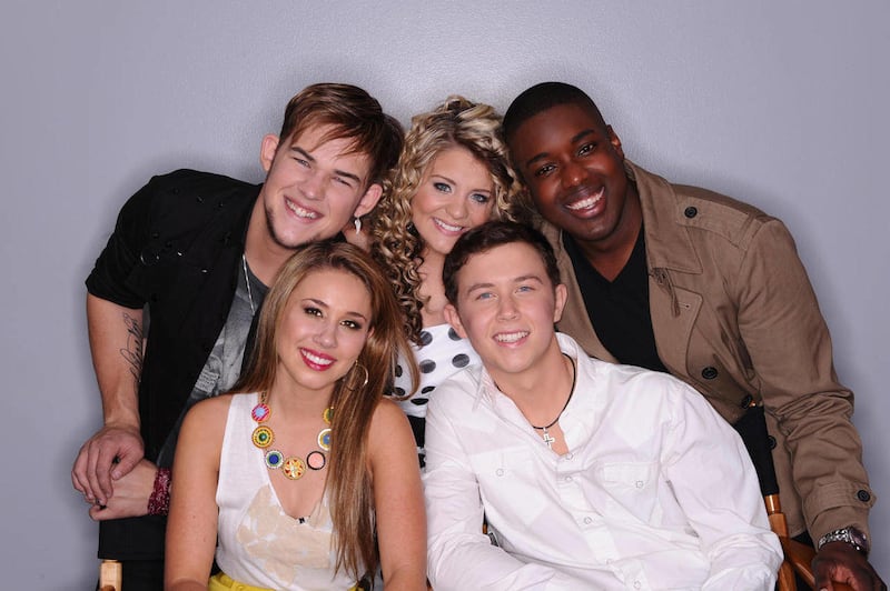In this April 28, 2011 photo released by FOX, the remaining contestants on the singing competition series, "American Idol," clockwise from back row left, James Durbin, Lauren Alaina, Jacob Lusk, Scotty McCreery and Hayley Reinhart are shown in Los Angeles