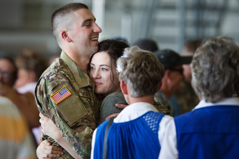 Samantha Taylor hugs Alex Taylor of the Utah National Guard before he is deployed to the Middle East at the Roland R. Wright Air National Guard Base in Salt Lake City on Monday, June 4, 2018.