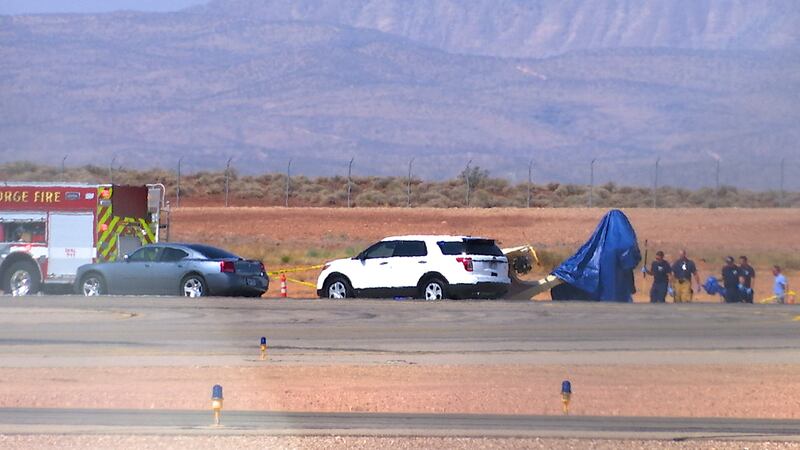 Emergency personnel place a blue tarp on the tail of an aircraft that crashed at St. George Regional Airport, killing the pilot, Sterling Palmer, 69, of St. George, on Saturday, Aug. 11, 2018.