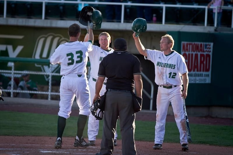 Goose Kallunki (33), Austin Heaps and Billy Burgess (12) celebrate a home run. The three UVU seniors each received All-America honors in 2012.