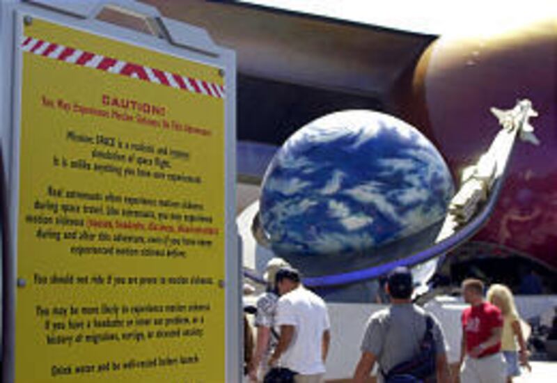 A sign cautions guests at Walt Disney World's Mission: Space attraction about motion sickness, dizziness and other possible side effects.