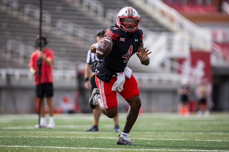 Utah quarterback Devon Dampier scrambles during a scrimmage at Rice-Eccles Stadium Aug. 15, 2025.